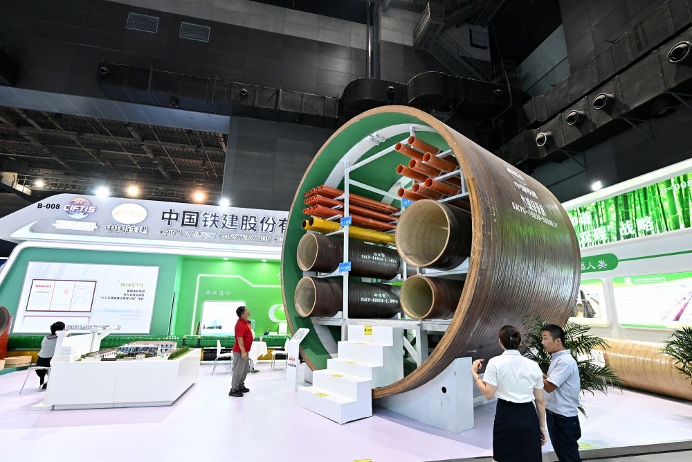 9月2日，在國(guó)家體育館舉行的服貿(mào)會(huì)環(huán)境服務(wù)專題展上，客商在中國(guó)鐵建展位竹纏繞管廊旁了解信息。新華社記者 李鑫 攝