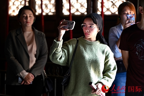 選手顏青（蘇丹）用手機(jī)記錄所見所感。人民網(wǎng) 盧鵬宇攝