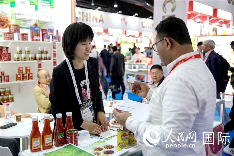 圖為中國參展企業(yè)代表與采購商交流。人民網(wǎng) 塔里克·易卜拉欣攝