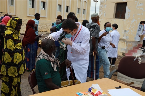 在義診現(xiàn)場，中國醫(yī)生與當(dāng)?shù)鼐用窈嫌傲裟?，吉布提鹽業(yè)投資公司供圖