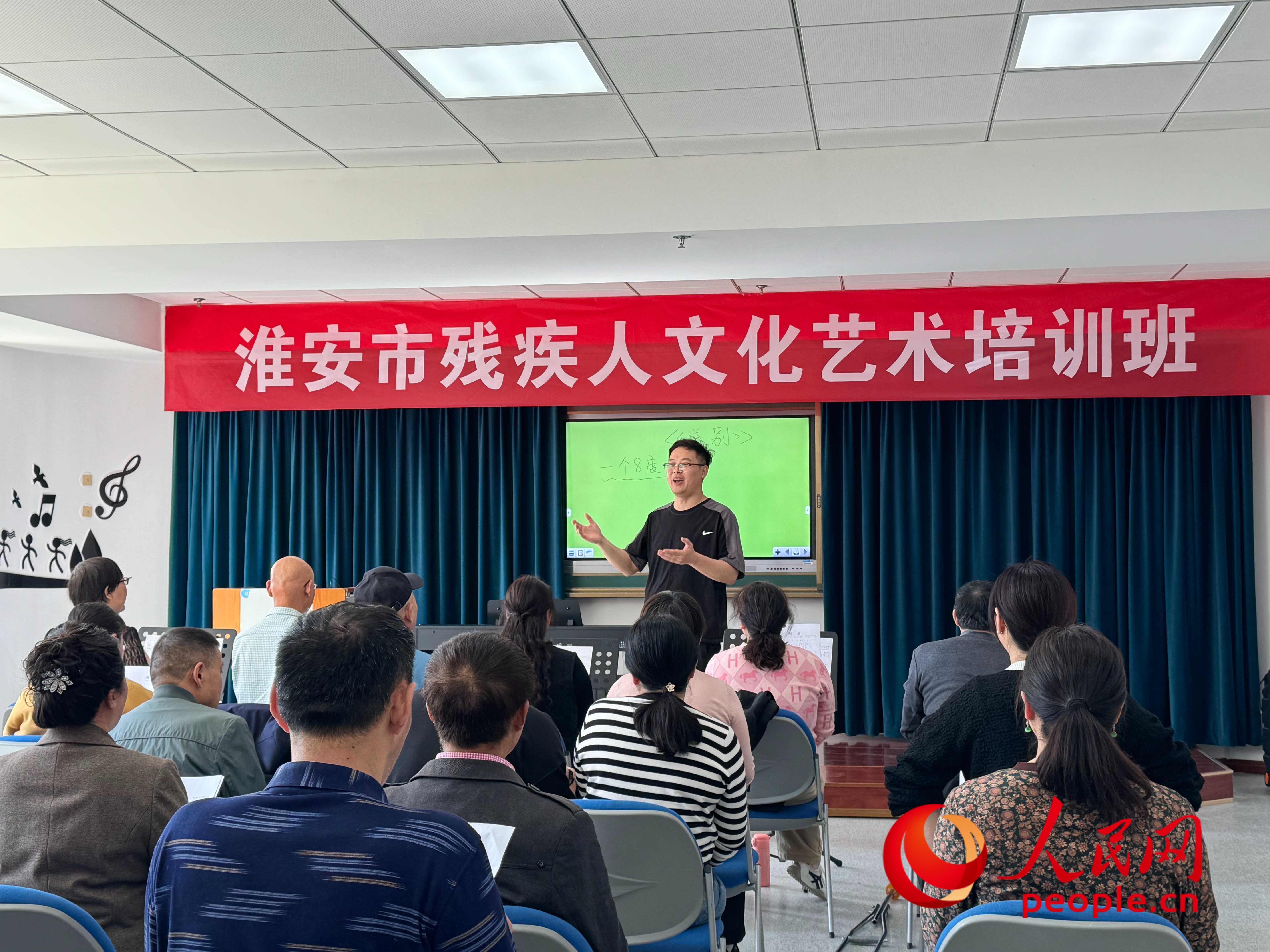 在淮安市殘疾人文化藝術(shù)培訓班上，聲樂老師在教殘疾人唱《送別》這首歌曲。人民網(wǎng) 周靜圓攝