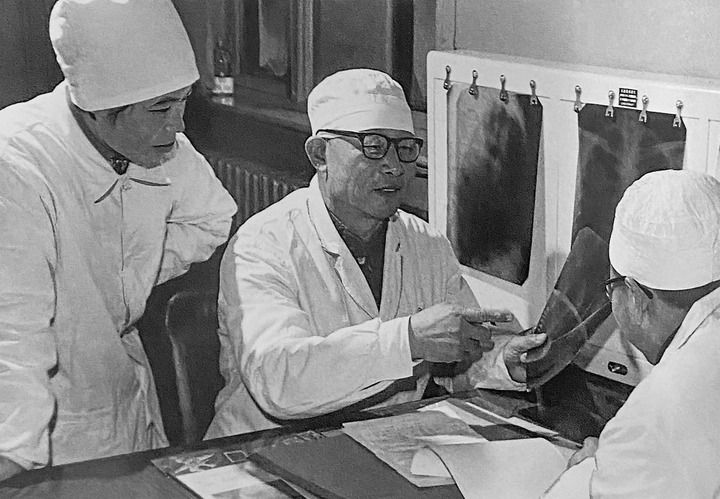 1980年1月16日，中日友好醫(yī)院首任院長辛育齡（中）在內(nèi)蒙古結(jié)核病院與胸外科醫(yī)師討論病例（翻拍照片）。 新華社發(fā)