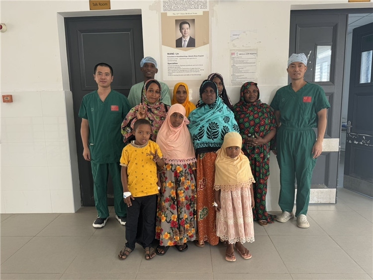 李廣（右一）和王林醫(yī)生與部分患者合影。中國援桑醫(yī)療隊供圖