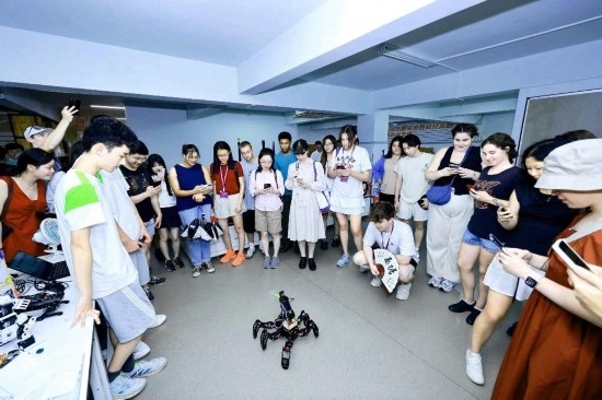 8月25日，中外青年在浙江杭州觀看機(jī)器人表演。新華社發(fā)（清華大學(xué)供圖）