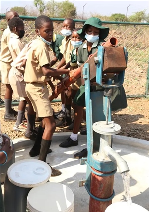 △2021年11月，在津巴布韋南馬塔貝萊蘭省省會(huì)關(guān)達(dá)的塞農(nóng)多小學(xué)，學(xué)生從中國(guó)援建水井里打水。