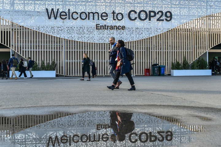 2024年11月15日，在阿塞拜疆首都巴庫，人們經(jīng)過聯(lián)合國氣候變化巴庫大會的會場。新華社記者 曹陽 攝