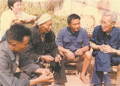 侯光炯（右一）和農(nóng)民在一起親切交流。 西南大學(xué)檔案館供圖
